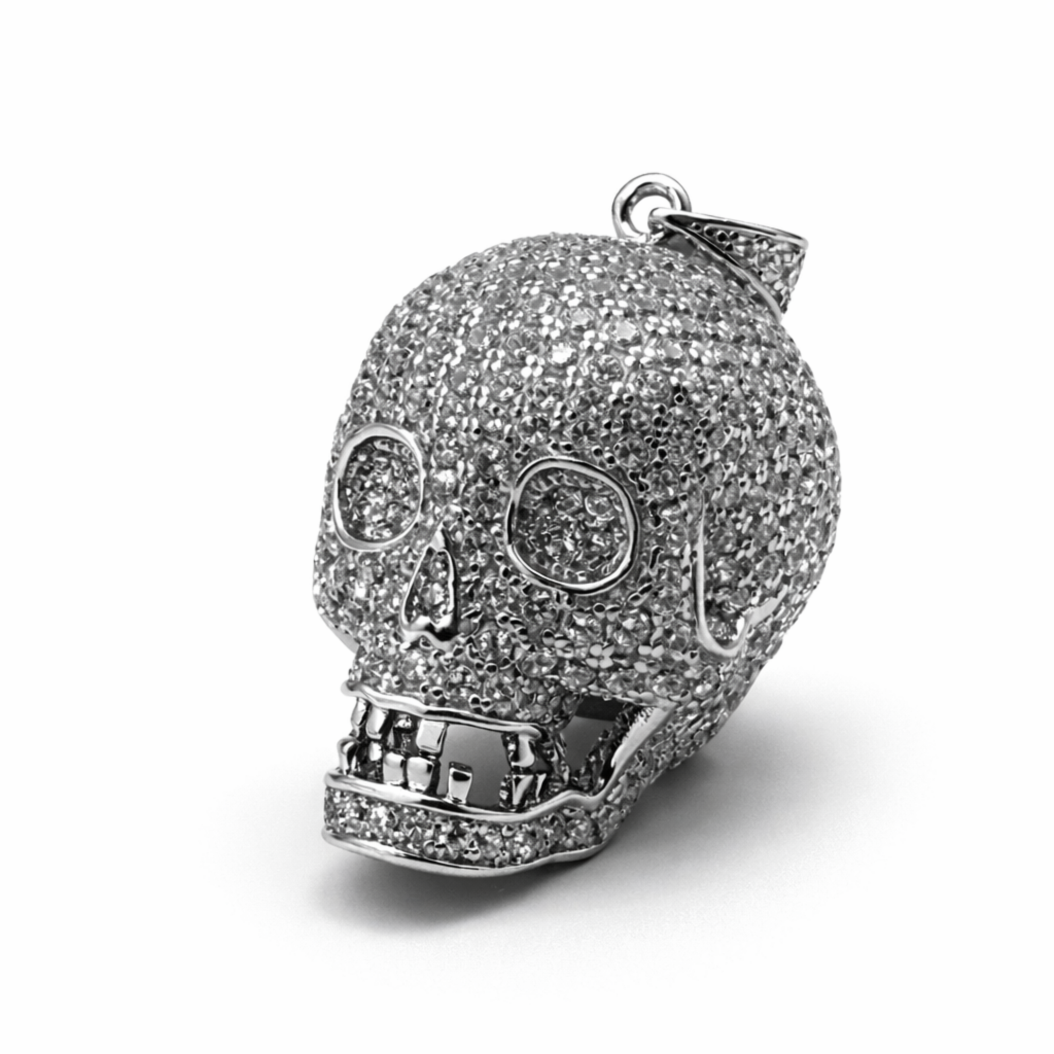 Sterling silver skull pendant encrusted with cubic zirconia on a white background