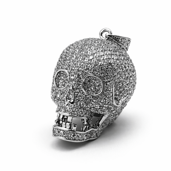 Sterling silver skull pendant encrusted with cubic zirconia on a white background