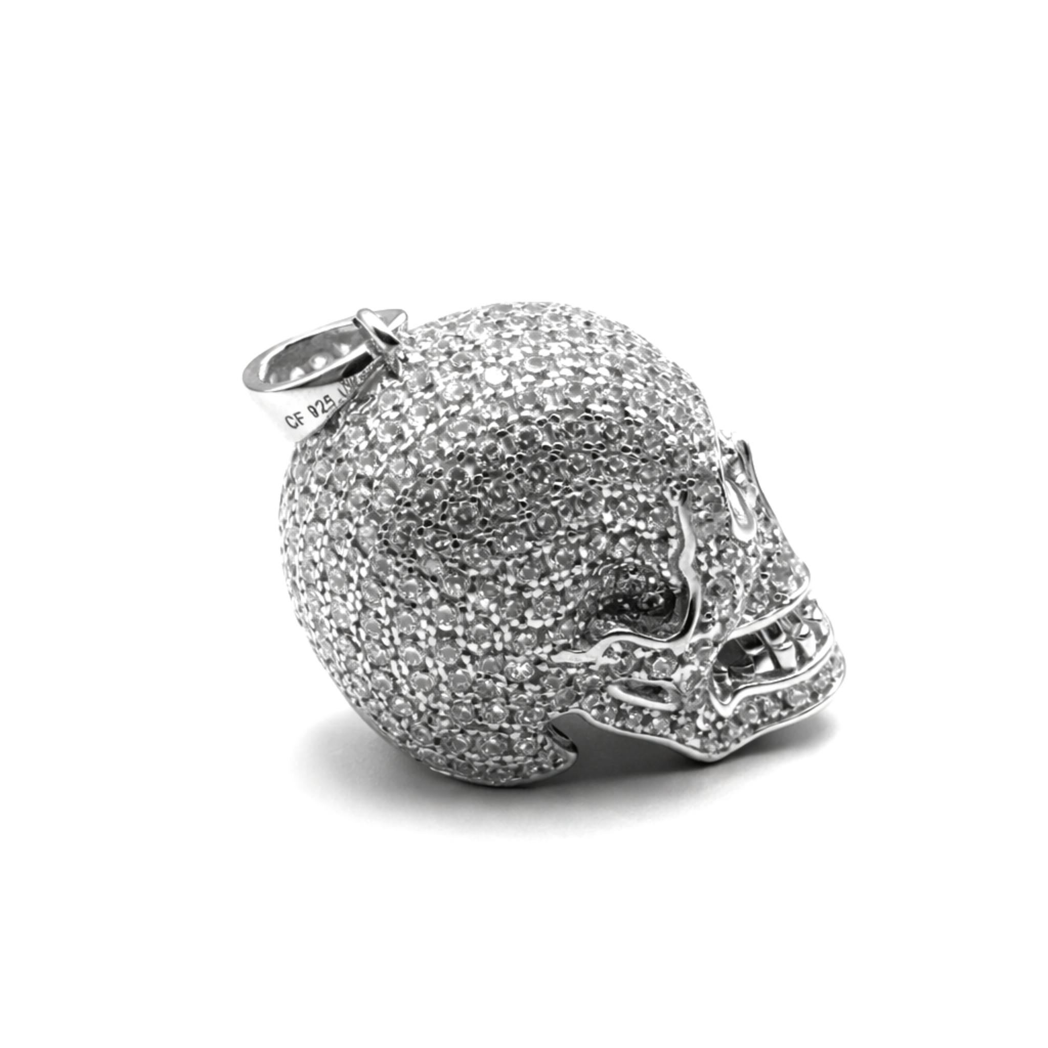Sterling silver skull pendant encrusted with cubic zirconia side angle on a white background