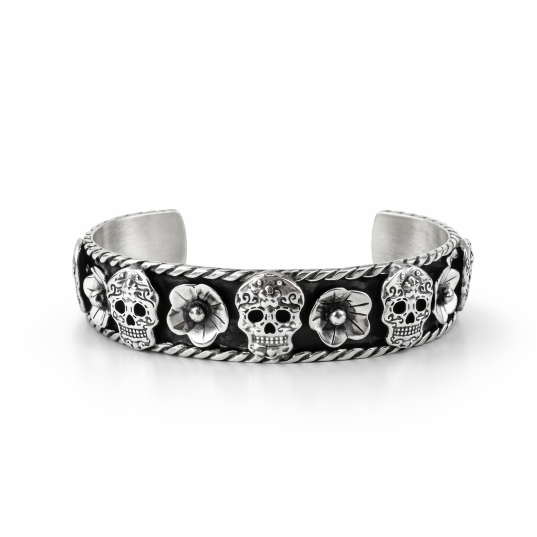Sterling silver cuff bracelet with skull and flower design and oxidised finish on white background, front view