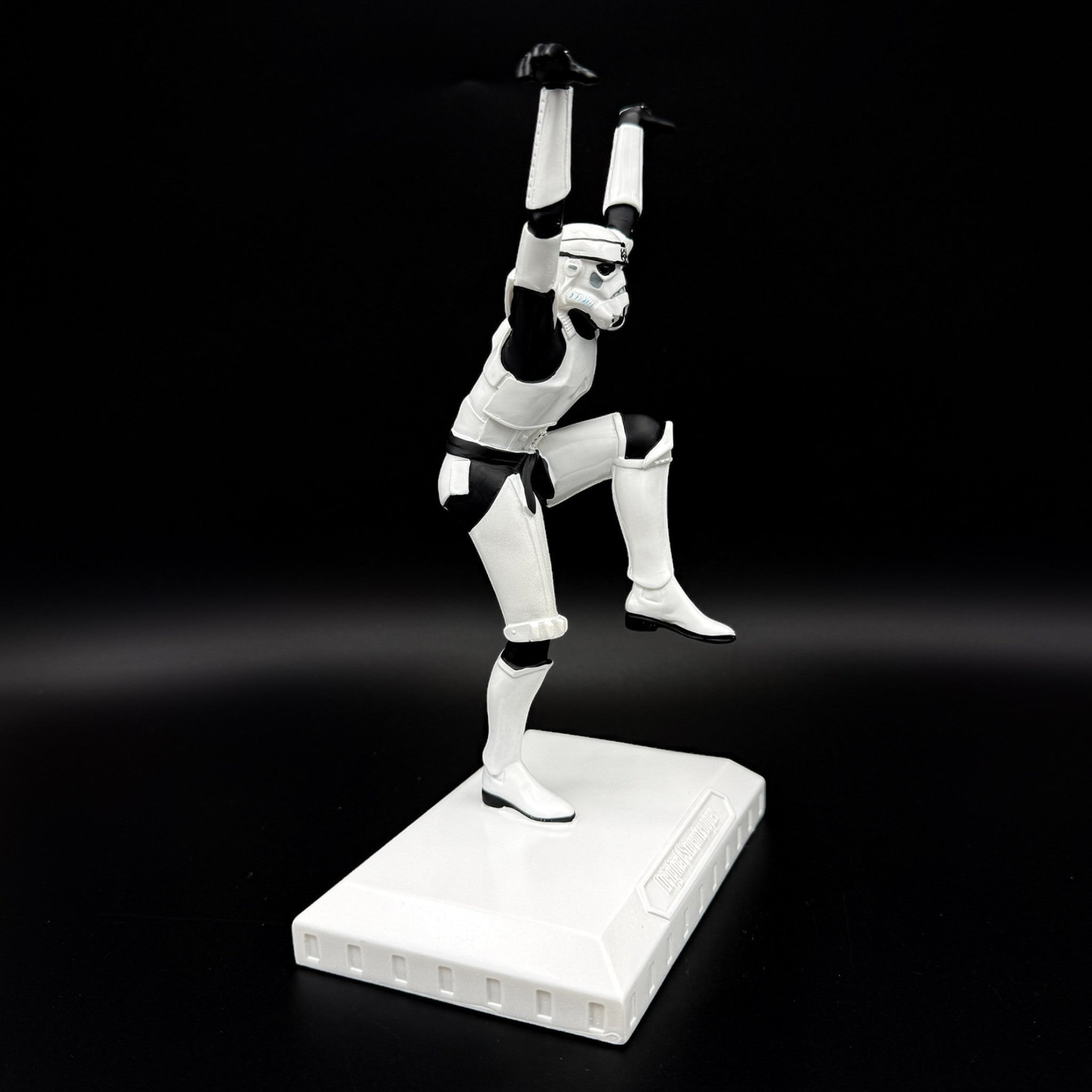 Side view of an officially licensed Stormtrooper Crane Kick figurine balancing on one leg in a martial arts pose on a display base.