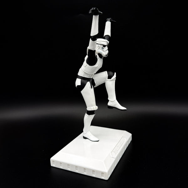 Side view of an officially licensed Stormtrooper Crane Kick figurine balancing on one leg in a martial arts pose on a display base.