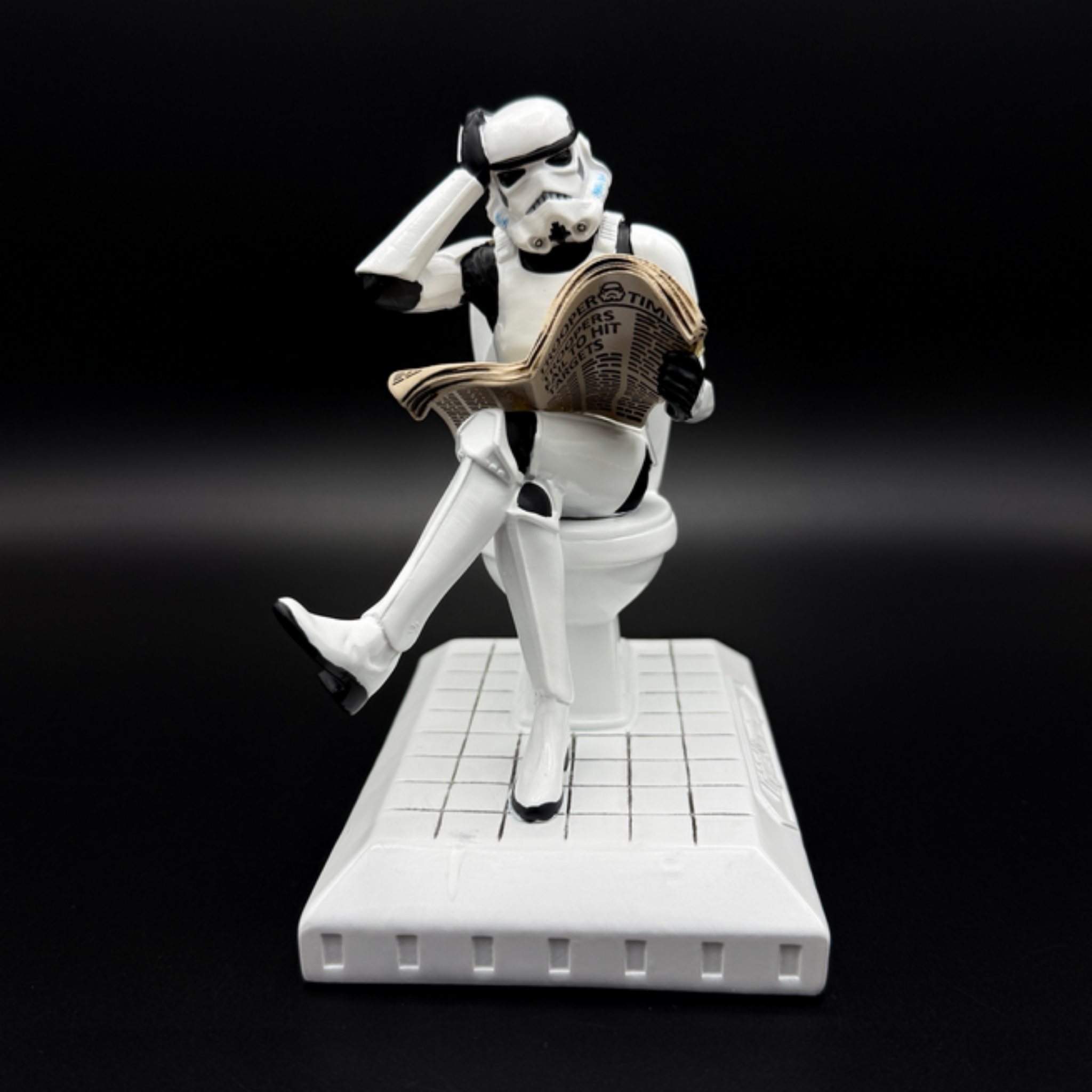 Officially licensed Stormtrooper Pooper Trooper figurine sitting on a toilet reading a newspaper front view