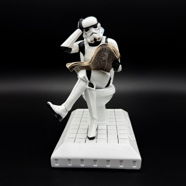 Officially licensed Stormtrooper Pooper Trooper figurine sitting on a toilet reading a newspaper front view
