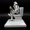 Officially licensed Stormtrooper Pooper Trooper figurine seated on a toilet reading a newspaper left side view