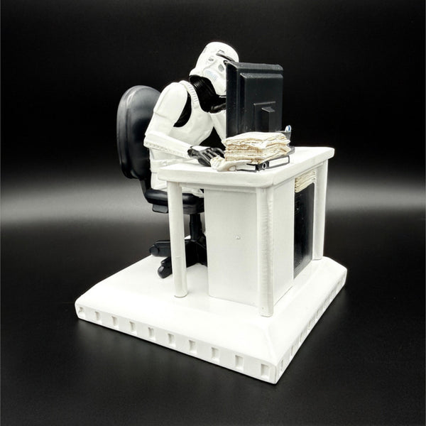 Original Stormtrooper Slave to the Wage figurine side view showing a tired Stormtrooper sitting at an office desk with paperwork and computer
