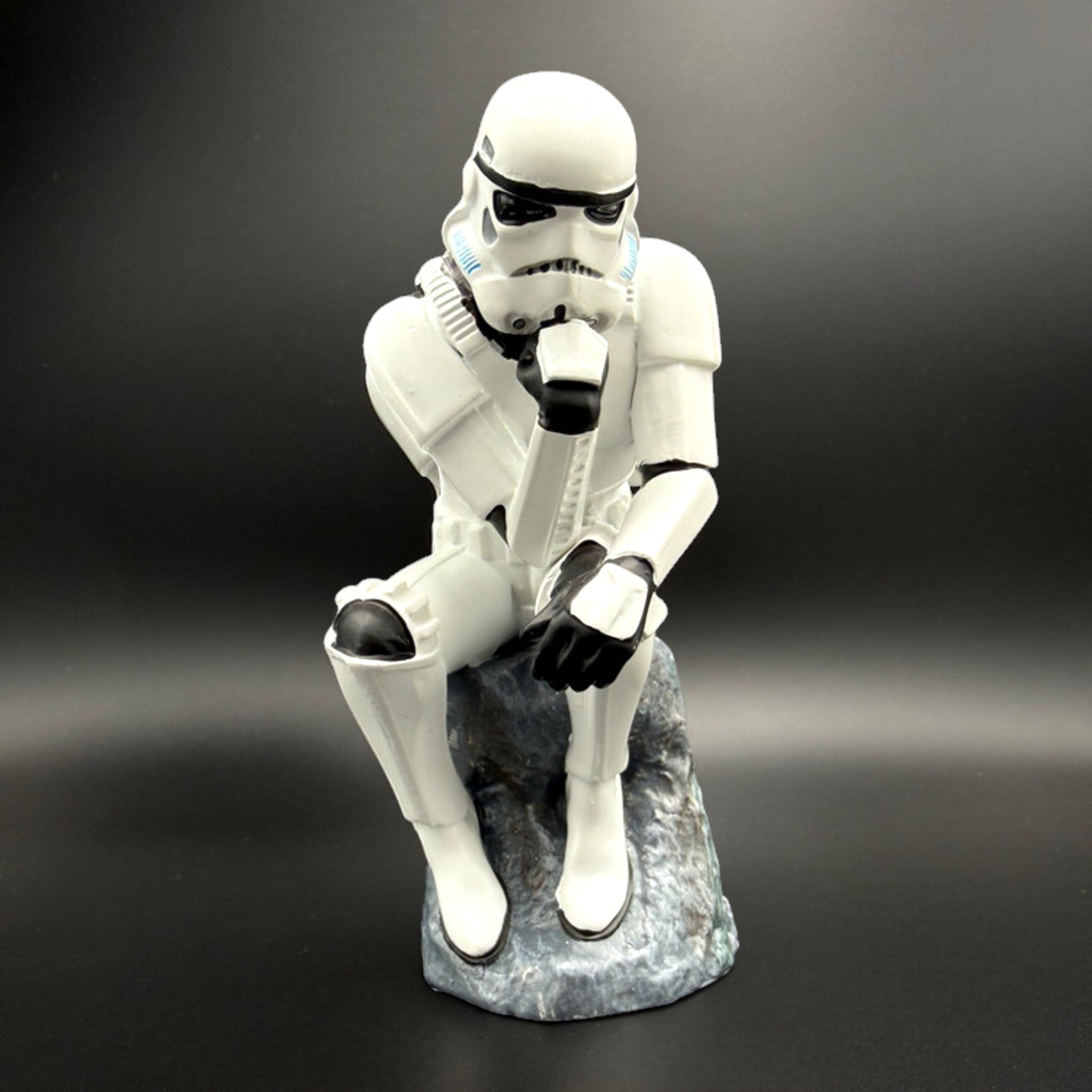Stormtrooper The Overthinker figurine front view sitting on rock base in thinker pose