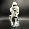 Stormtrooper The Overthinker figurine front view sitting on rock base in thinker pose