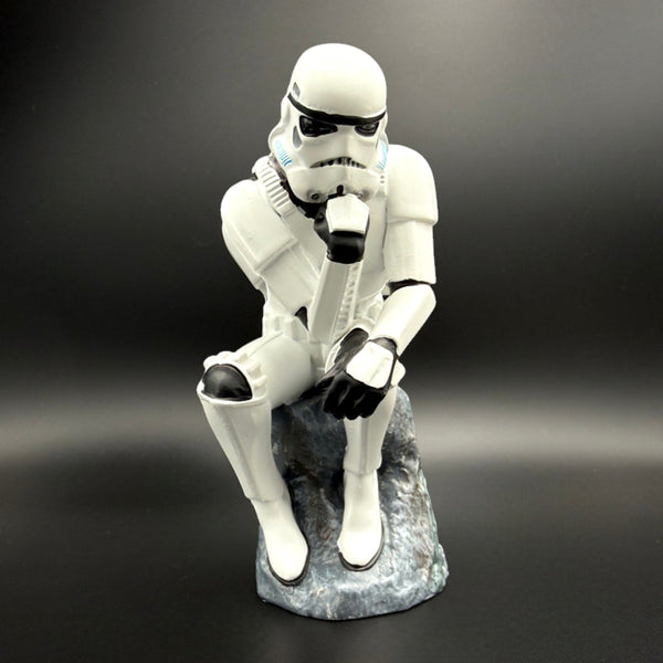Stormtrooper The Overthinker figurine front view sitting on rock base in thinker pose