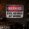 Close up of a Warning Evil Genius At Work metal sign in a moody industrial man cave setting