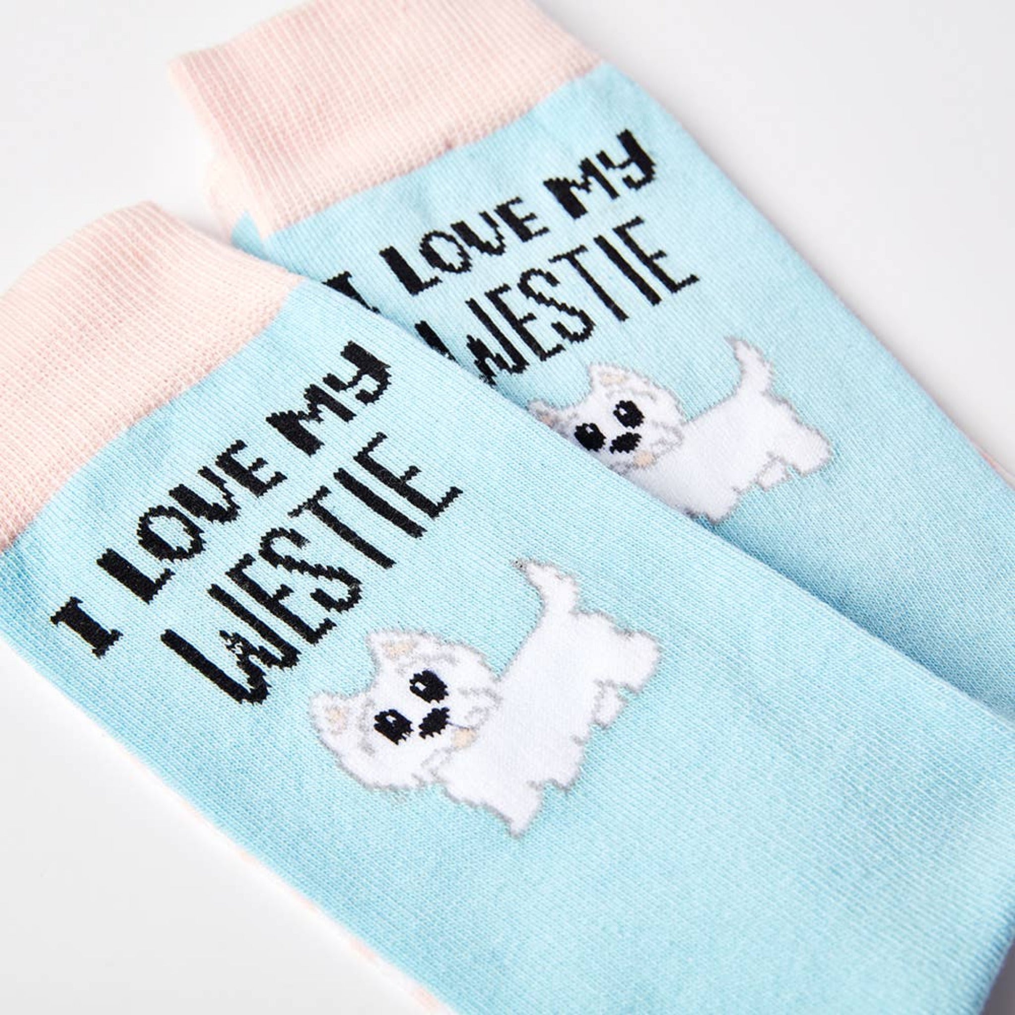 close up of I Love My Westie socks showing dog design and text